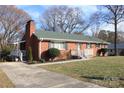 Quaint brick home with a well-manicured lawn, offering classic charm and inviting curb appeal at 1060 Laurel Ln, Gastonia, NC 28054