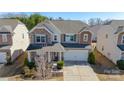 Beautiful two-story home with stone accents, manicured lawn, and a two-car garage at 1100 Wallace Lake Rd, Fort Mill, SC 29707