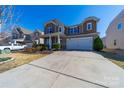 Charming two-story home featuring stone accents, a two-car garage, and a well-maintained lawn at 1100 Wallace Lake Rd, Fort Mill, SC 29707