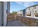 Private wooden balcony offers an intimate space for relaxation, enhancing the townhome's appeal at 11017 Woodland Creek Way, Charlotte, NC 28262