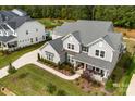 An aerial view of a home showing the roof, lawn and landscaping on a sunny day at 13108 Brooklyn Skylar Way, Huntersville, NC 28078