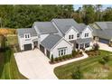 Aerial view of a spacious home with a three-car garage and well-maintained lawn at 13108 Brooklyn Skylar Way, Huntersville, NC 28078