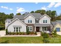 Attractive two-story home featuring a landscaped yard, stone accents and welcoming front porch at 13108 Brooklyn Skylar Way, Huntersville, NC 28078