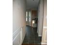 Hallway with tiled floor, and decorative trim, providing an inviting transition to the kitchen space at 14922 Rolling Sky Dr, Charlotte, NC 28273