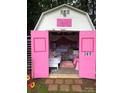 Playful shed featuring pink accents, decorative elements, and a functional interior at 14922 Rolling Sky Dr, Charlotte, NC 28273