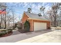 Brick home with attached two-car garage, well-maintained landscaping, and paved walkway leading to the front entrance at 1531 Wheaton Nw Way, Concord, NC 28027