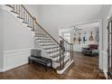 Staircase with wood and metal details, with an entrance to a cozy seating area at 18334 Dembridge Dr, Davidson, NC 28036