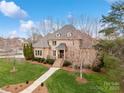 Beautiful brick home featuring well-maintained landscaping and elegant architectural details at 1838 Landry Ln, Rock Hill, SC 29732