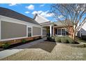 Inviting home exterior featuring stone accents, manicured landscaping, and a covered entrance at 2018 Links View Dr, Fort Mill, SC 29707