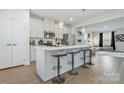 Open kitchen design with a large island, pendant lighting, and barstool seating flowing into the living area at 2175 Autumn Cyprus Ave, Gastonia, NC 28054