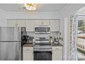 Updated kitchen featuring stainless steel appliances and subway tile backsplash at 2500 Cranbrook Ln # 2, Charlotte, NC 28207