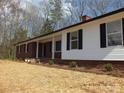 A cozy home boasts a brick facade, complemented by fresh landscaping and a welcoming covered porch in a serene neighborhood at 2739 Great Falls Hwy, Lancaster, SC 29720