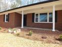 Charming brick home with a cozy front porch, black shutters, and fresh landscaping creating a welcoming curb appeal at 2739 Great Falls Hwy, Lancaster, SC 29720