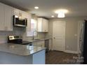 Modern kitchen featuring white cabinets, granite countertops, subway tile backsplash, and stainless steel appliances at 2739 Great Falls Hwy, Lancaster, SC 29720