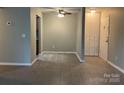 View of open living room with tile flooring and a ceiling fan at 300 Orchard Trace Ln # 3, Charlotte, NC 28213