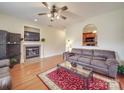 Cozy living room features a fireplace, ceiling fan, and seamless view into the kitchen at 3253 Ian Patrick Ave, Kannapolis, NC 28083