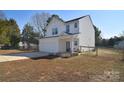 Attractive two-story home showcases a two-car garage and a cozy front porch at 345 Corinth Church Rd, Mooresville, NC 28115