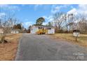 Exterior view of a charming white brick home with a long driveway at 356 Hill Rd, Lincolnton, NC 28092