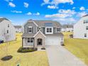 Beautiful two-story home boasting stone accents, attached garage, and lush front lawn at 367 Kennerly Center Dr, Mooresville, NC 28115