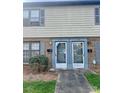 Inviting entry to the townhome with brick facade, modern door and manicured landscape at 4520 Central Ave # C, Charlotte, NC 28205
