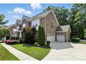 Beautiful brick home with a three-car garage and well-maintained landscaping, showing a spacious driveway at 4708 Pearmain Dr, Waxhaw, NC 28173