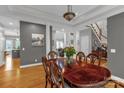 Formal dining room with hardwood floors, large wood table, decorative columns, and neutral wall color at 507 Saint Johns Dr, Salisbury, NC 28144