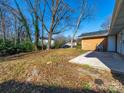 Spacious backyard with mature trees, offering a peaceful and private setting at 5600 Burleson Dr, Charlotte, NC 28215