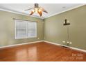 Bright bedroom with hardwood floors, a ceiling fan, and a large window providing natural light at 616 Smokehouse Ln, Albemarle, NC 28001