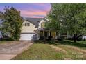 Charming two-story home with an attached garage and inviting front porch at 6720 Neuhoff Ln, Charlotte, NC 28269