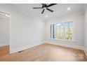 Light filled bedroom featuring hardwood floors and a modern ceiling fan at 810 Martingale Ln, Davidson, NC 28036