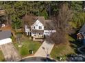 Aerial view of a two-story home surrounded by mature trees and a well-maintained lawn in a cul-de-sac at 9131 Strattonville Ct, Huntersville, NC 28078