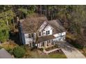 Aerial view of home featuring a cozy front porch, mature landscaping, and an attached two-car garage at 9131 Strattonville Ct, Huntersville, NC 28078