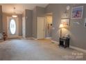 A view of the entry way of the house that includes light-colored walls, and dark brown carpet at 103 Pine Meadows Cir, Hickory, NC 28601