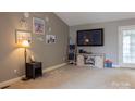 Cozy living room featuring carpet floors, warm neutral paint, with beach-themed decor at 103 Pine Meadows Cir, Hickory, NC 28601