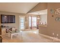 Open-concept living area with neutral walls, a vaulted ceiling, and bright windows for ample natural light at 103 Pine Meadows Cir, Hickory, NC 28601