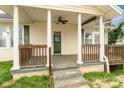 Inviting covered front porch with decorative columns and ceiling fan at 1111 W 4Th Ave, Gastonia, NC 28052