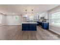 Bright, open kitchen featuring blue cabinets, quartz countertops, and stainless steel appliances at 1114 University Dr, Lancaster, SC 29720