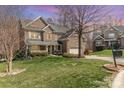 Charming two-story brick home featuring a well-manicured lawn and attached two-car garage at 1347 Lightwood Dr, Matthews, NC 28105