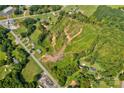 This aerial view captures a vast lot, embraced by flourishing trees and adjacent to a serene road at 1414 S Post Rd, Shelby, NC 28152