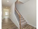 Bright foyer featuring hardwood floors, a staircase, and neutral paint at 1620 Troon Dr, Salisbury, NC 28144