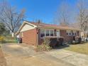 Well-maintained brick home with a spacious driveway and a manicured landscape at 2210 Milton Rd, Charlotte, NC 28215