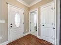 Bright foyer with an oval glass front door and wood-look flooring at 2375 Ellison Cir, Lancaster, SC 29720