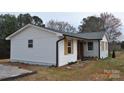 A newly renovated home with crisp white siding and light wood shuttered windows at 2400 Pressley Rd, Chester, SC 29712