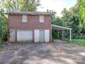 Brick two-story detached garage with multiple bays and covered parking at 303 Wade St, Wadesboro, NC 28170