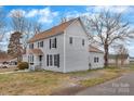 Inviting two-story home showcasing its light gray exterior, brown roof, and spacious yard at 315 E Washington Ave, Bessemer City, NC 28016