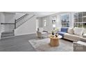 Bright living room with neutral decor, gray wood floors, and ample natural light at 315 E Washington Ave, Bessemer City, NC 28016