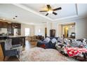 An open floor plan living room features hardwood flooring, modern furniture and opens to the kitchen at 330 Chinquapin Ln, Mt Ulla, NC 28125