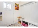 Well-organized mud room with built-in bench, hooks, and storage cubbies at 3941 Rothwood Ln, Harrisburg, NC 28075