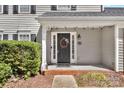 Close-up of a welcoming front door with decorative wreath and exterior lighting at 4007 Hermes Ln, Waxhaw, NC 28173