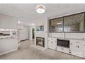 Spacious living room with a brick fireplace, built-in shelving, adjacent to the kitchen at 424 Virginia Ave, Statesville, NC 28677